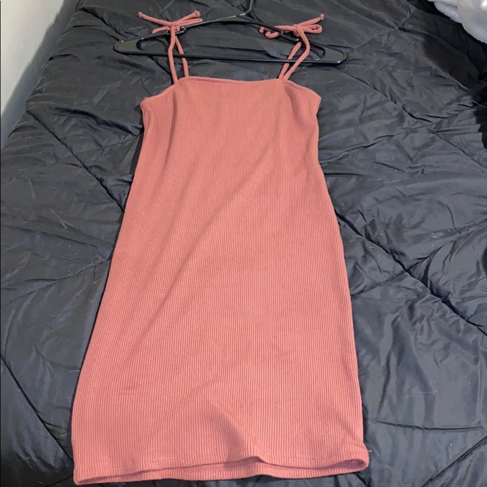 A salmon tight fitted dress